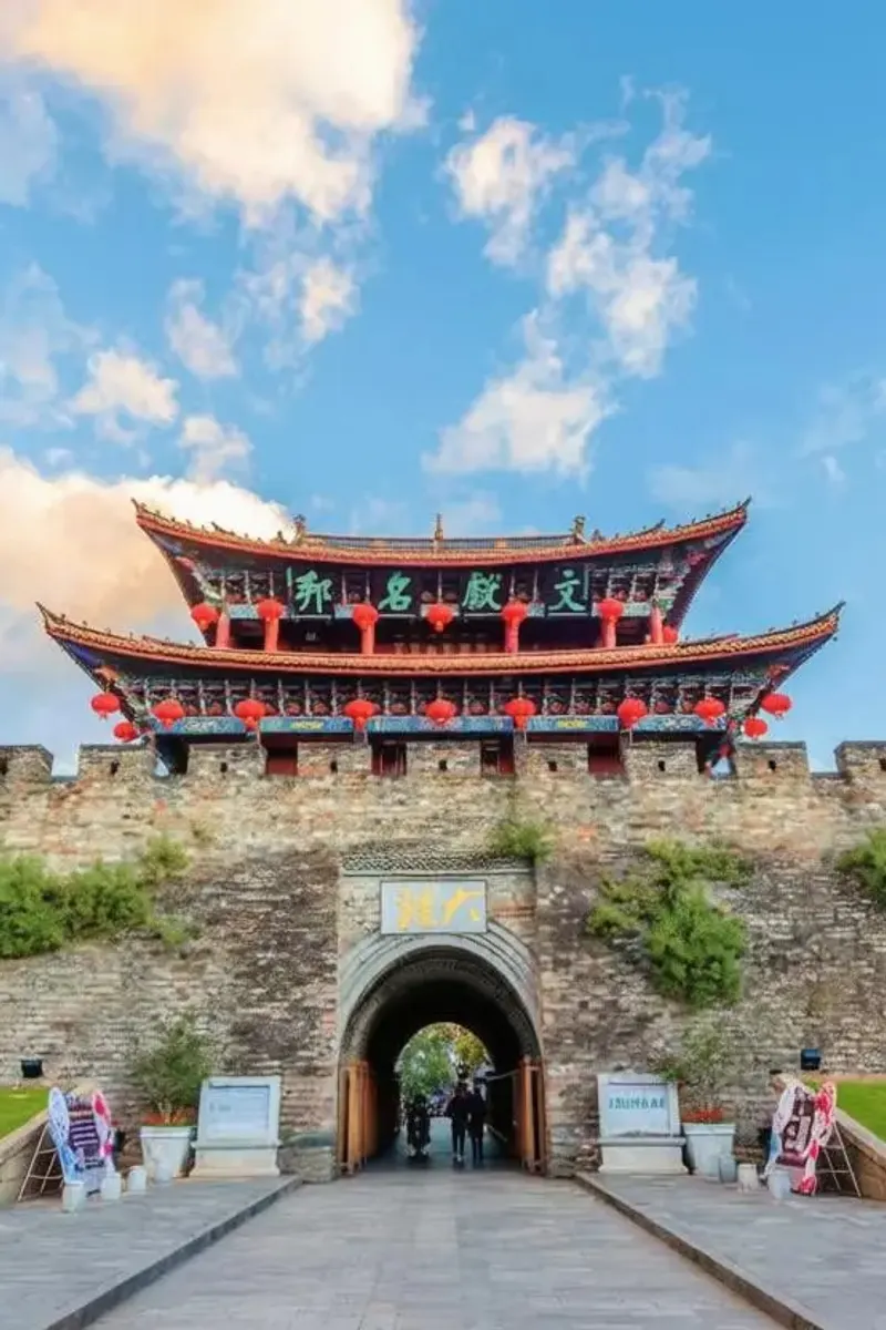 South gate of Dali Old Town with lanterns and flower beds