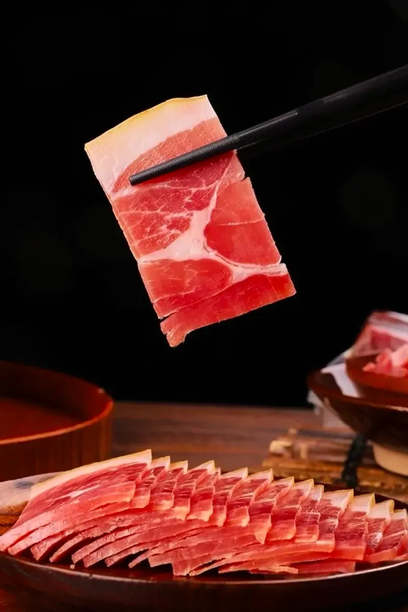 Thin slice of Xuanwei ham lifted with chopsticks