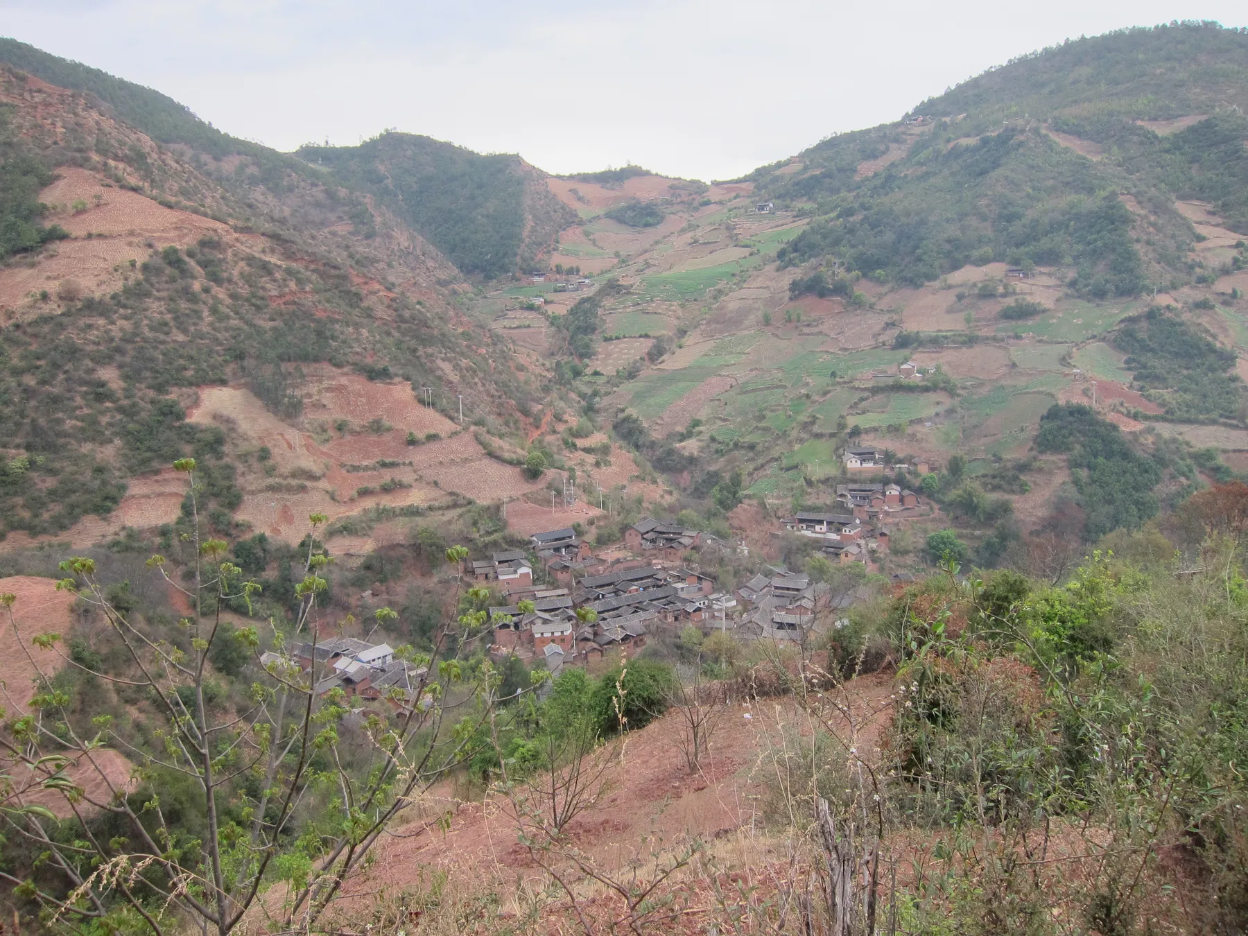 Nuodeng village clustered in a mountain valley in Yunlong County, Yunnan