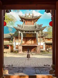 Traditional theater courtyard framed by an old doorway in Shaxi Ancient Town