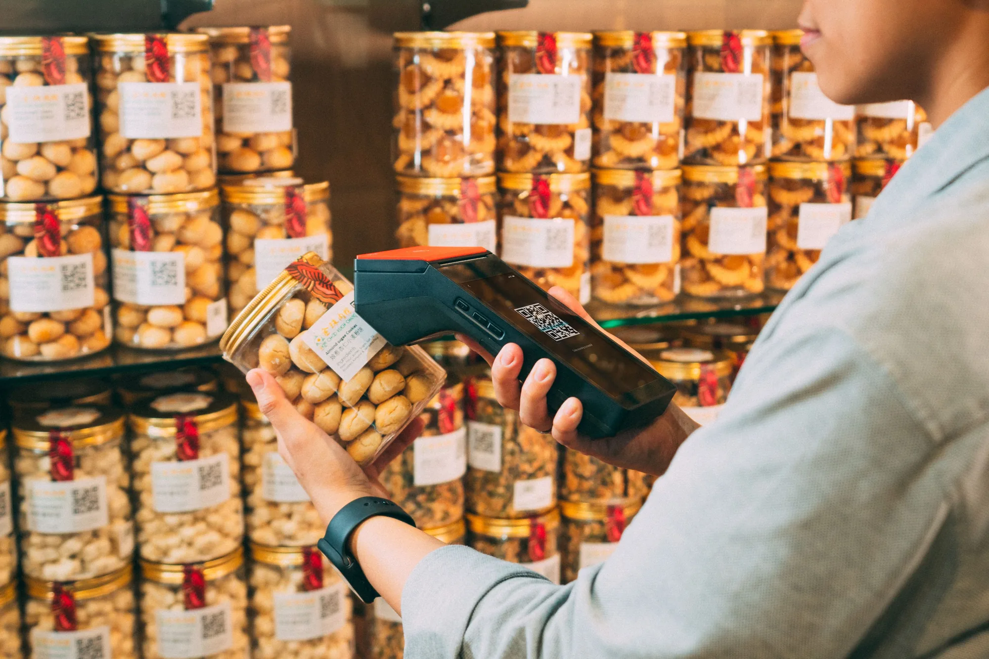 Shopper scanning a product label in a Chinese grocery