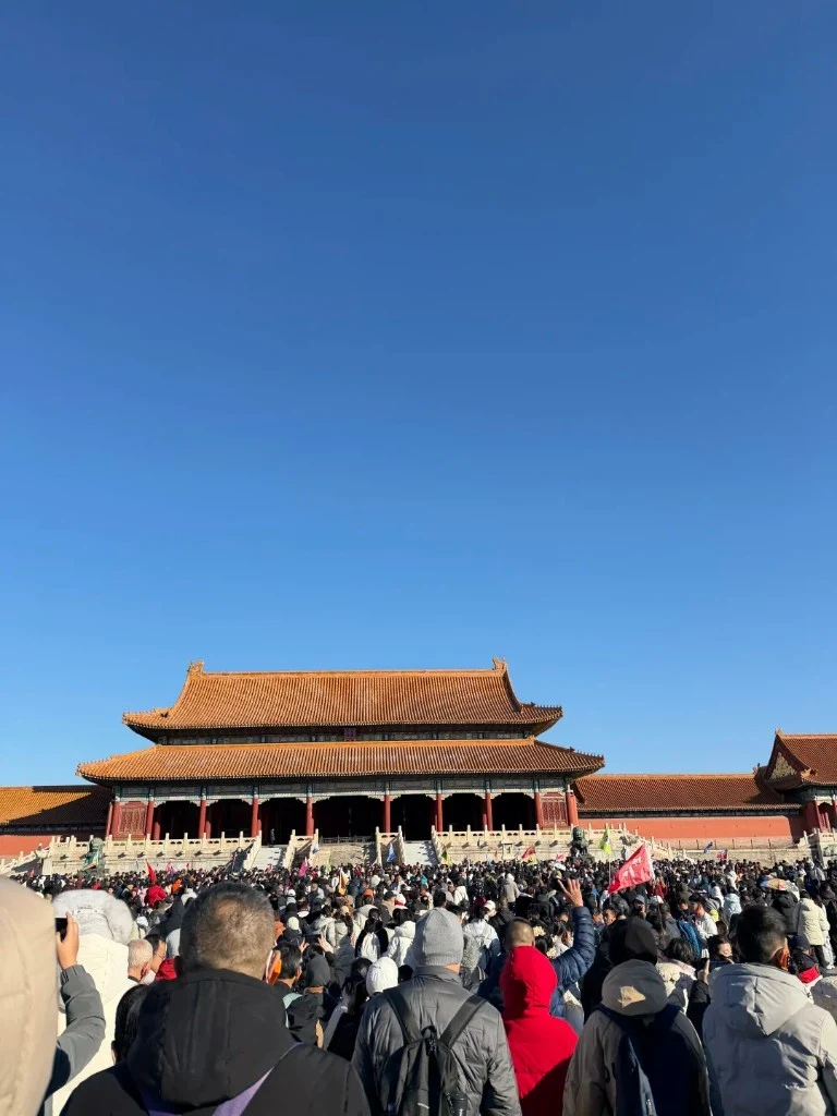 Dense tourist crowd inside the Forbidden City under a clear sky — why popular China attractions limit daily visitors